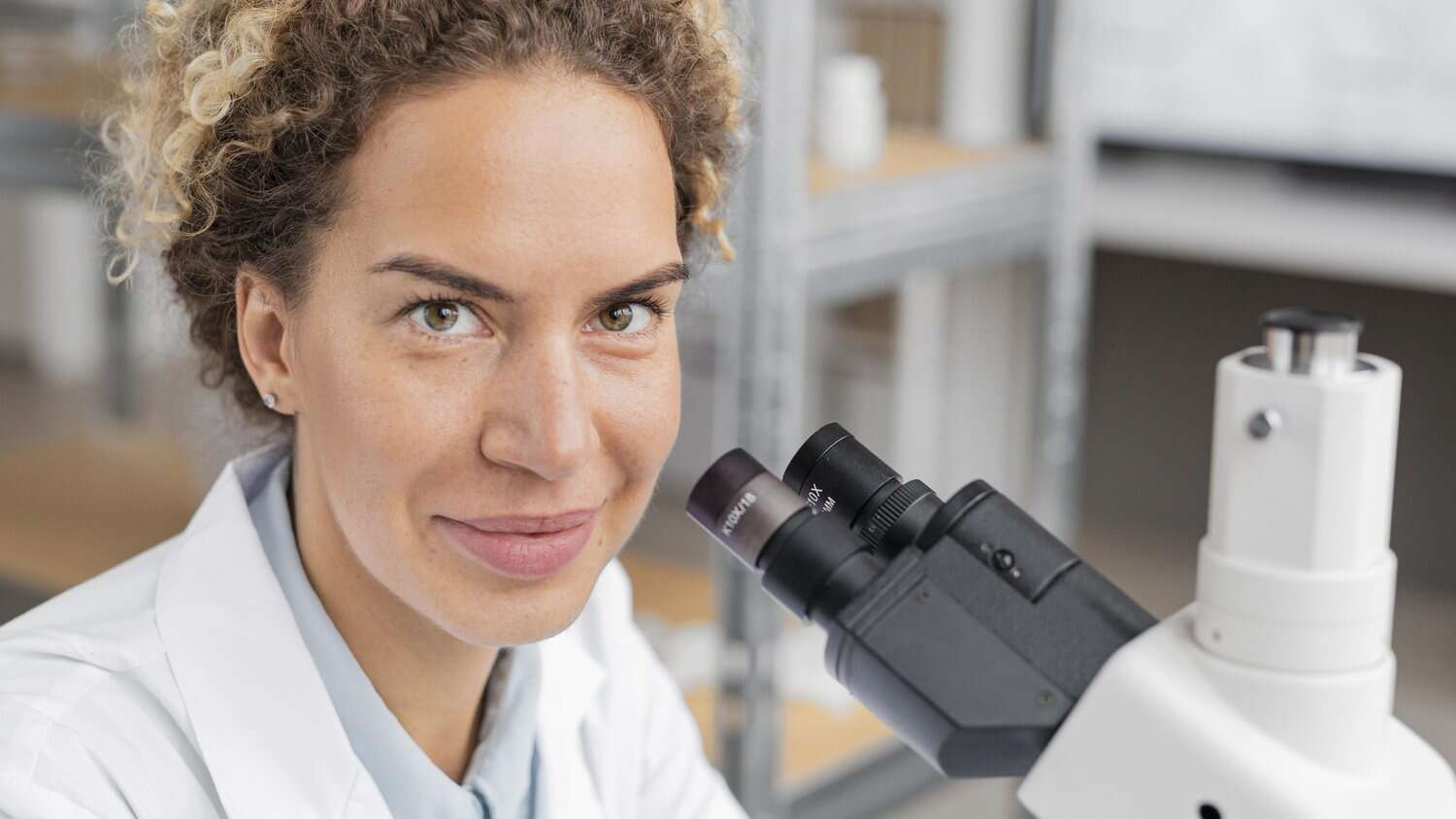 Researcher at a microscope